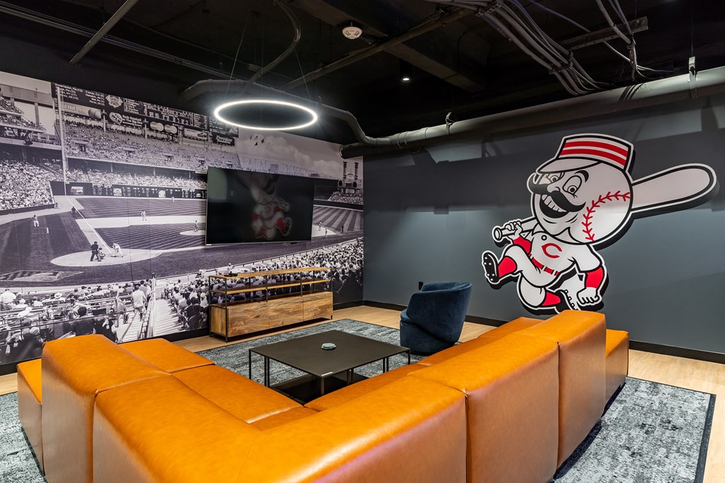 a wall mural of a baseball player in a living room at Textile Apartments, Ohio, 45202