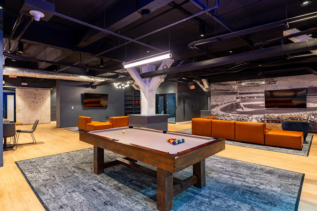 a game room with a pool table and a tv at Textile Apartments, Cincinnati, Ohio