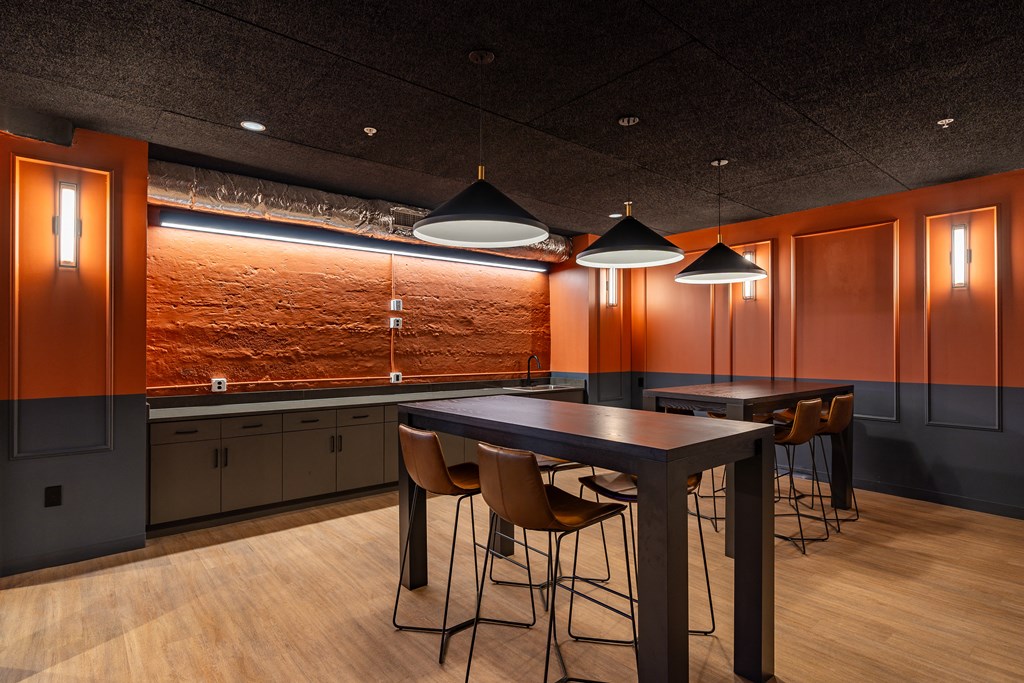 a dining room with a table and chairs and lamps at Textile Apartments, Cincinnati, OH