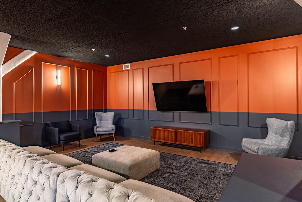 a living room with orange walls and a television at Textile Apartments, Cincinnati, 45202