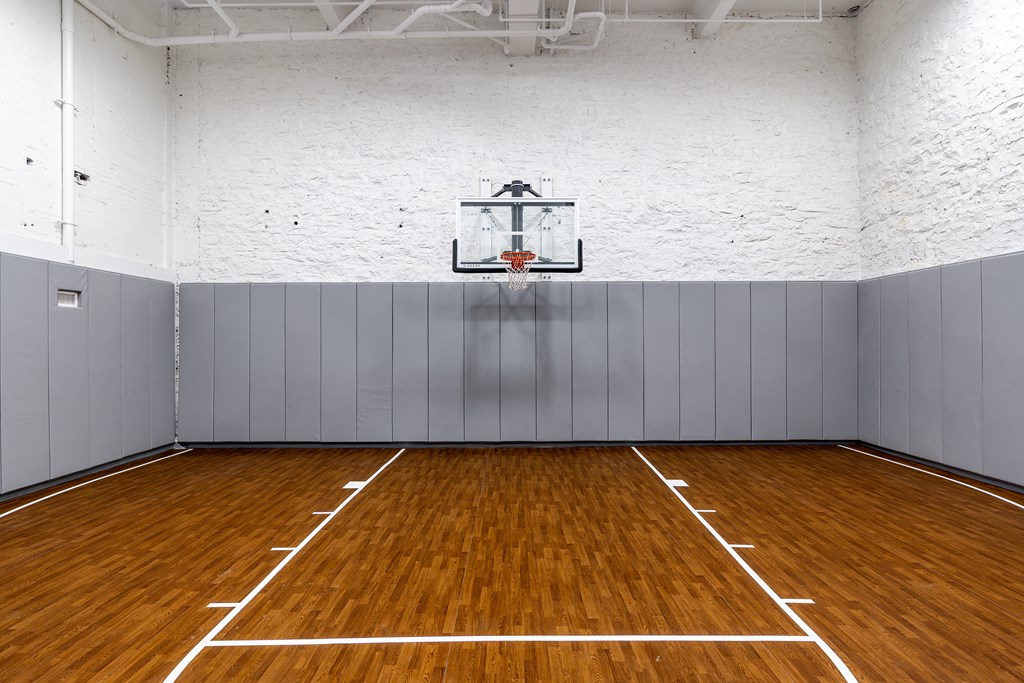 an empty basketball court in a gym with a basketball hoop at Textile Apartments, Cincinnati, OH, 45202