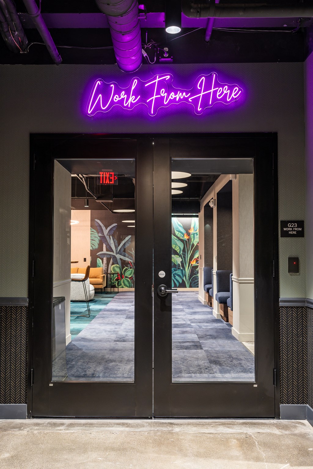 a purple neon sign above a door that reads work from home at Textile Apartments, Cincinnati, OH