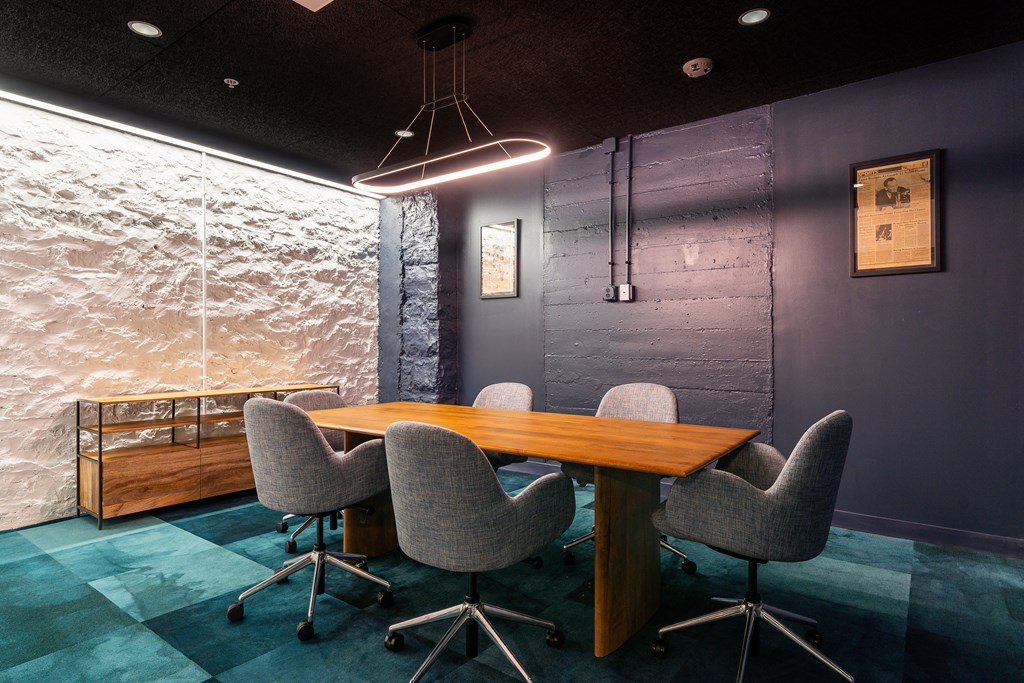 a conference room with a wooden table and chairs at Textile Apartments, Cincinnati, Ohio