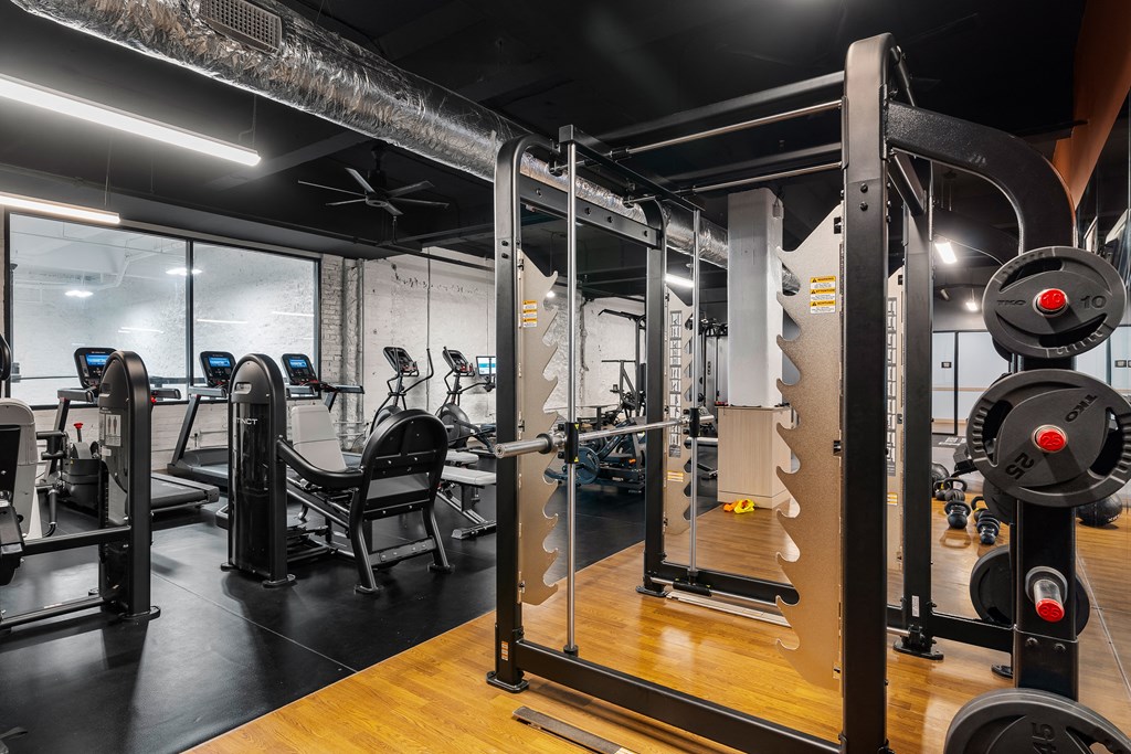 a fitness room with weights and other exercise equipment at Textile Apartments, Cincinnati, 45202