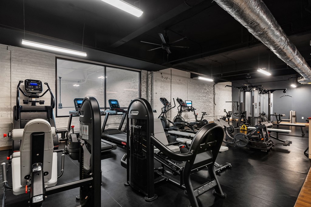 a gym with treadmills and other exercise equipment at Textile Apartments, Cincinnati