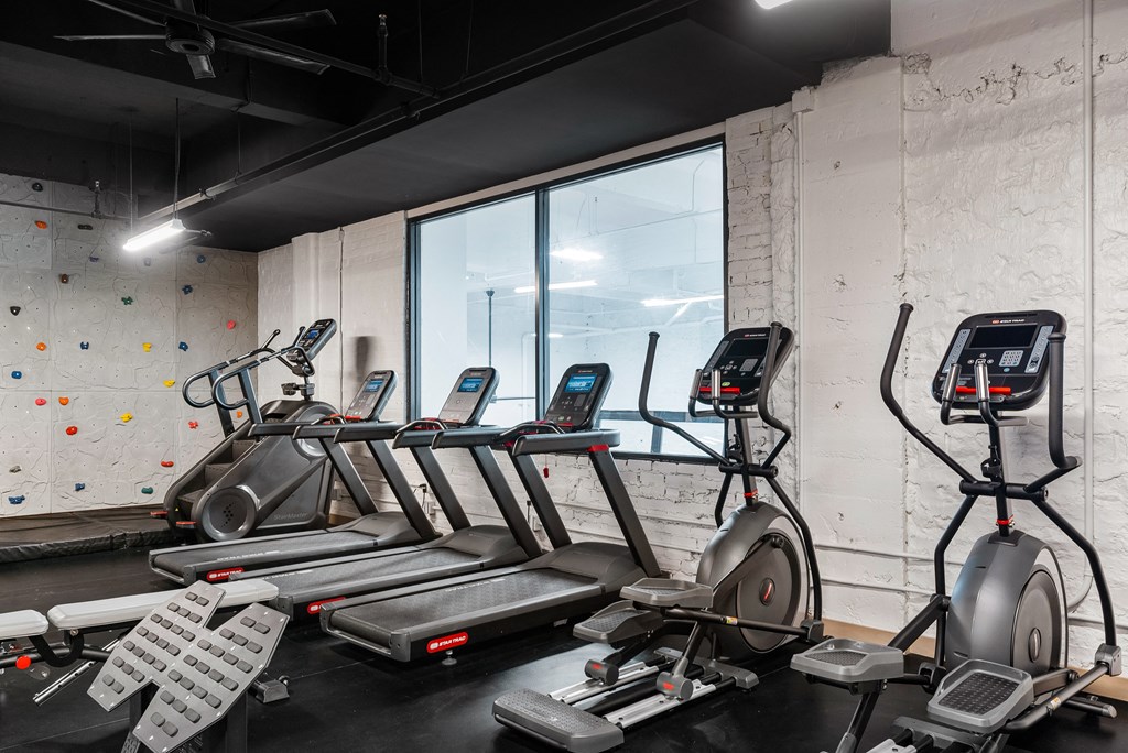 a group of treadmills and other exercise equipment in a gym at Textile Apartments, Ohio