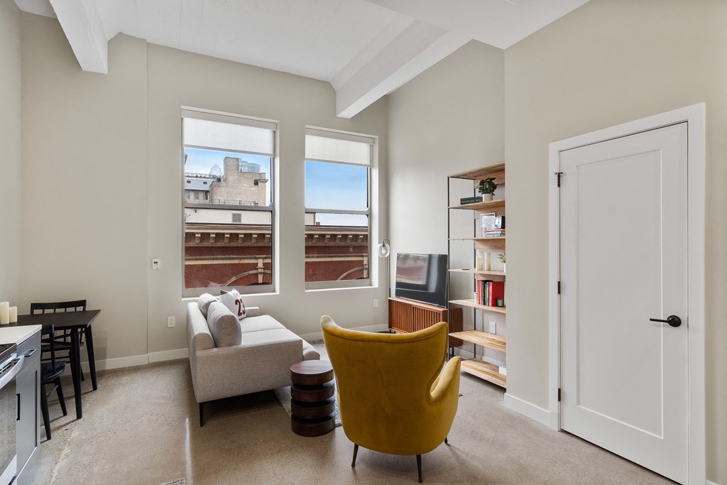 a living room with a couch and a chair and a window at Textile Apartments, Cincinnati, 45202