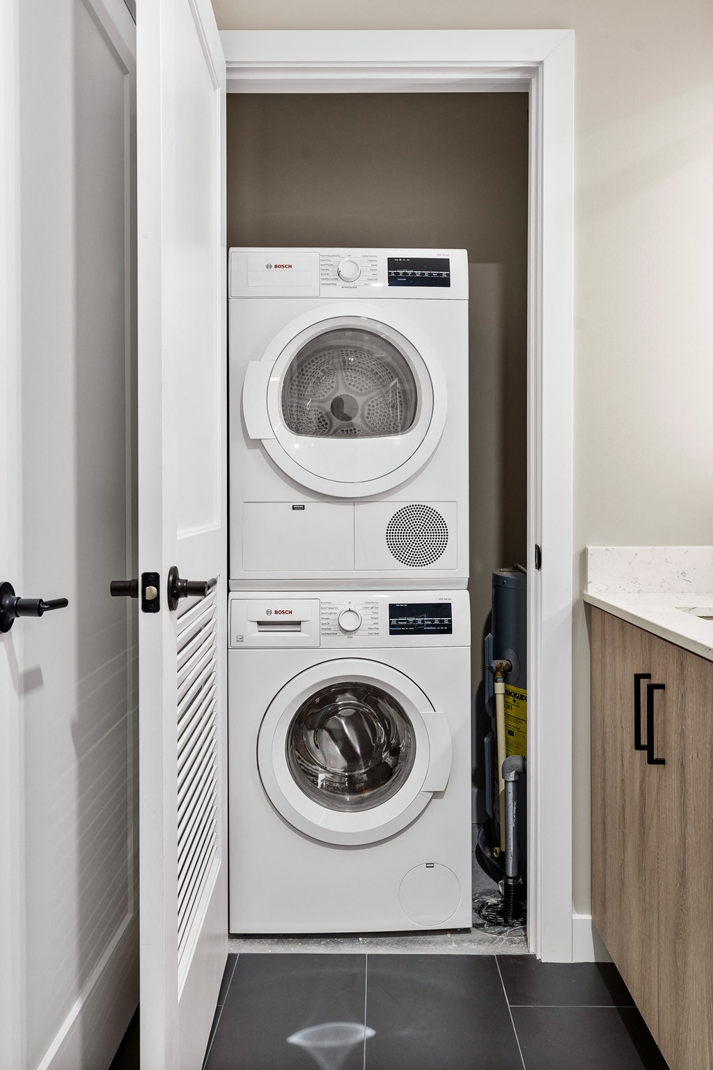 a white washer and dryer in a small laundry room at Textile Apartments, Ohio, 45202