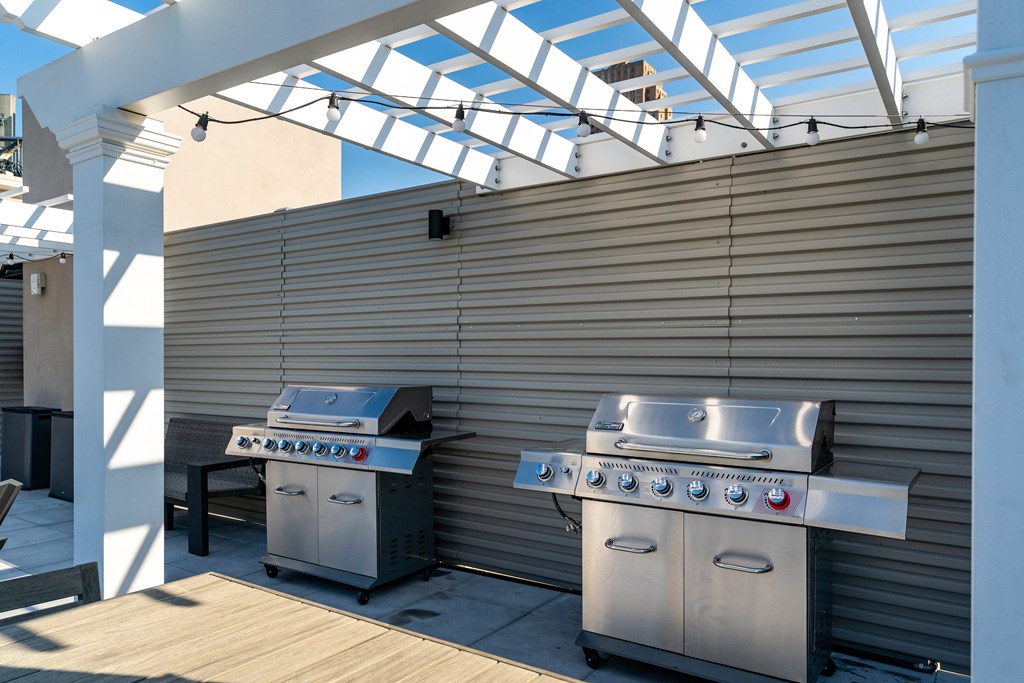 two stainless steel barbecue grills on a patio with a roof at Textile Apartments, Cincinnati, 45202