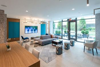 A modern living room with a wooden table and a grey sofa.