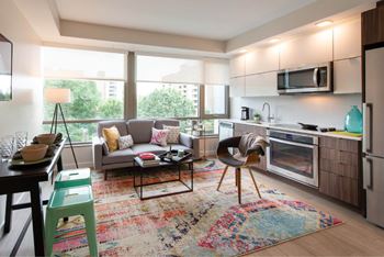 A modern kitchen with a dining table and chairs.