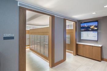 A modern office lobby with a TV screen showing a cityscape.