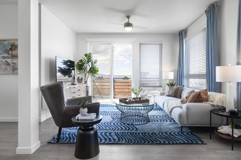 A living room with a brown chair and a blue rug.