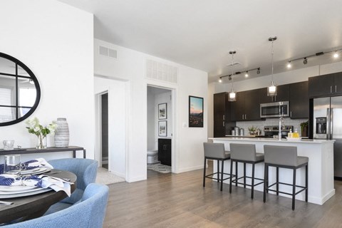 a living room and kitchen with a table and chairs