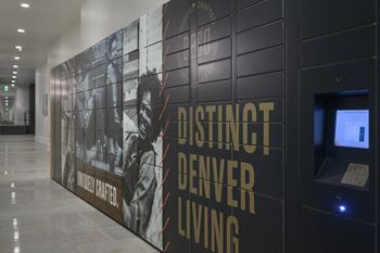 A wall with a sign that says Distinct Denver Living.