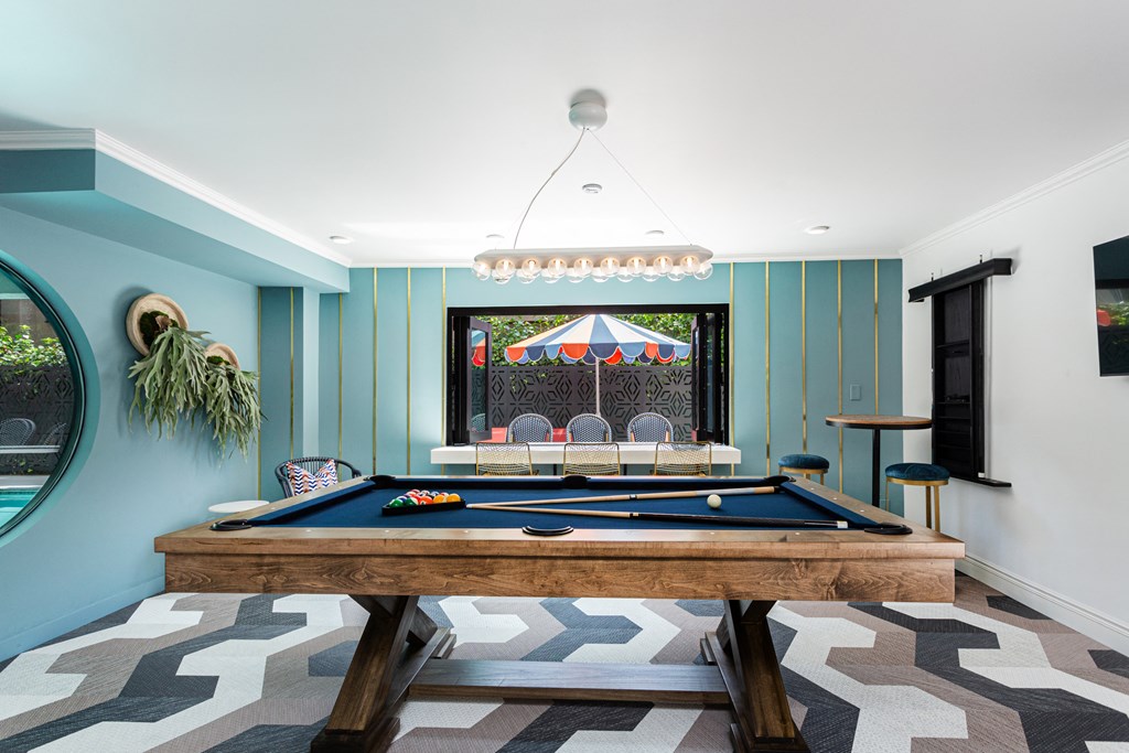 a pool table in a room with blue walls