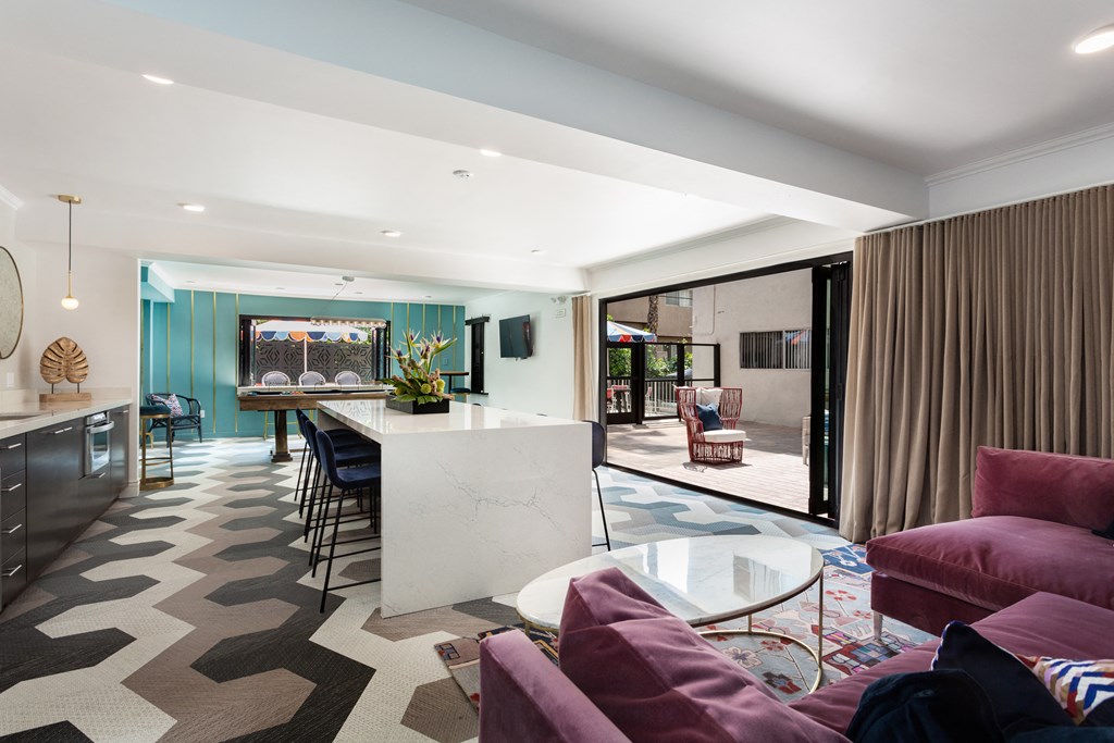 a living room with a kitchen and a dining room