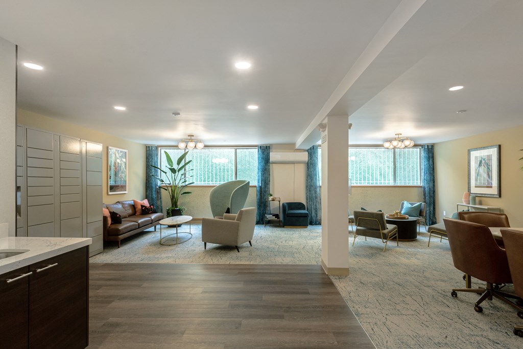 a living room with couches and chairs and a dining room