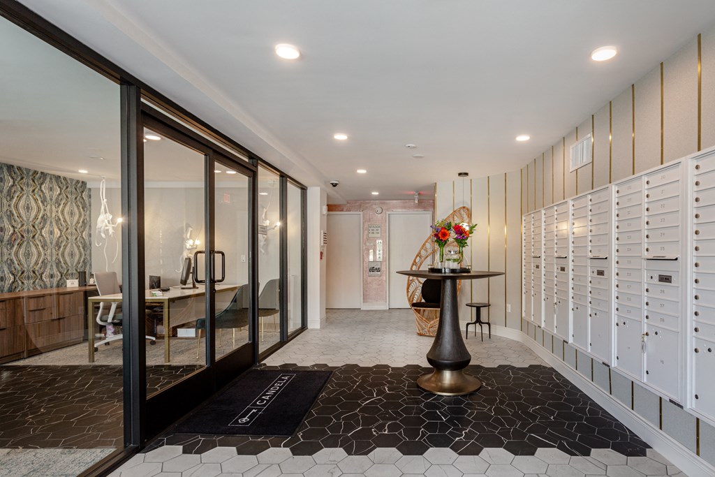 a walk in closet with lockers and a table with flowers