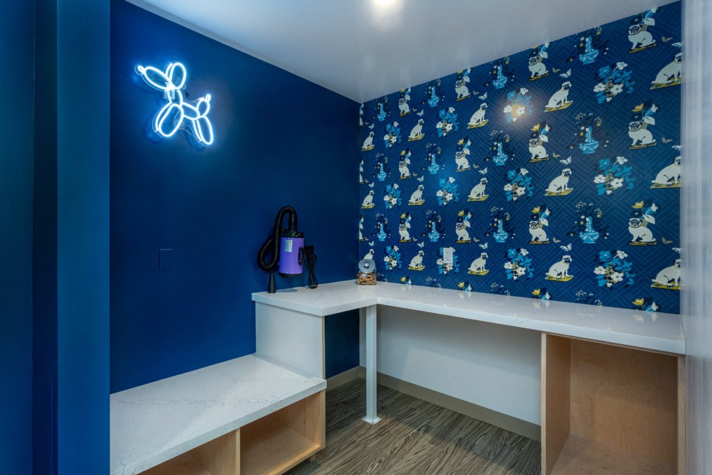 a room with a desk and a blue wall with a bike on it