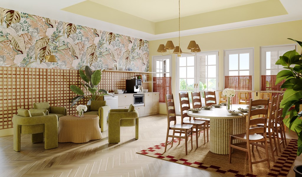 a living room with a table and chairs and a kitchen in the background
