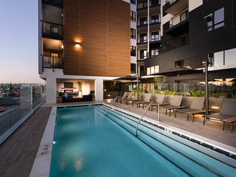 Outdoor pool area at night with lounge seating