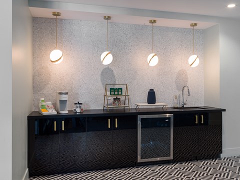 a kitchen with a black counter top and some lights