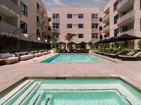 a swimming pool in front of an apartment building
