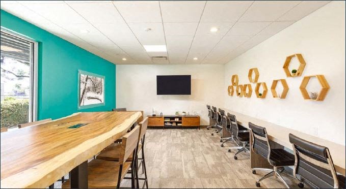 Community Indoor Lounge Space with Table and Desk Seating and TV