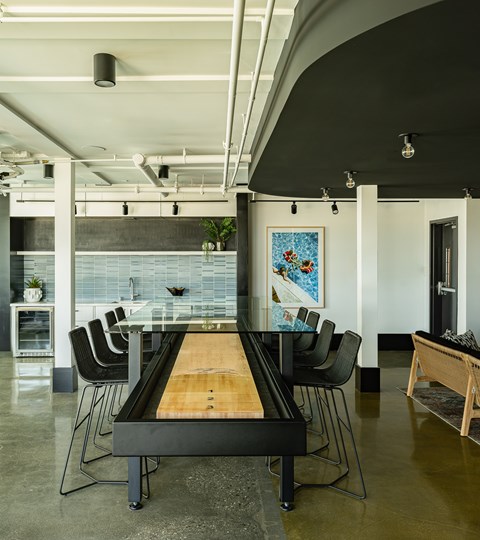 A modern dining room with a glass table and chairs.