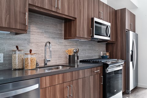 A modern kitchen with wooden cabinets and stainless steel appliances.