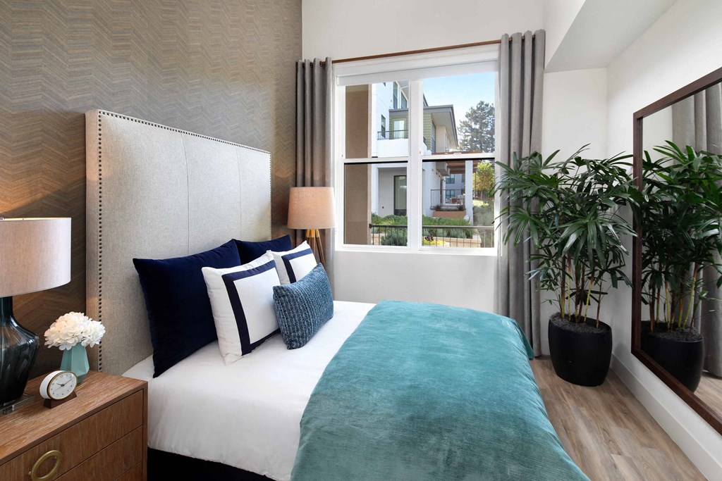 Luxurious Bedroom with large bed and mirror next to window