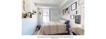 a bedroom with a bed and pictures on the wall