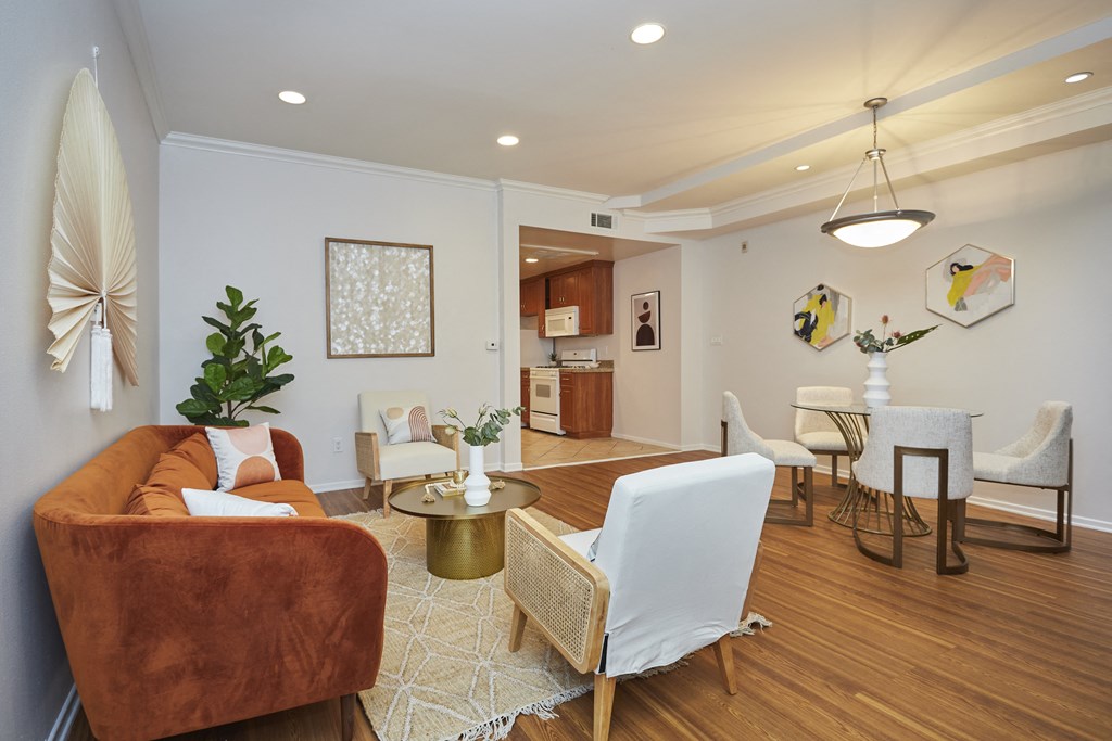 Spacious, bright living area with a couch, chairs, and dining table