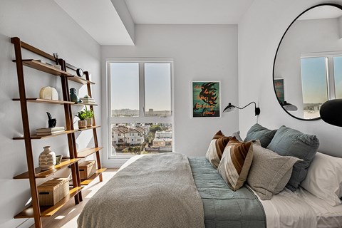 a bedroom with a bed and a large window
