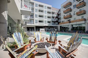 A poolside area with chairs and skis.