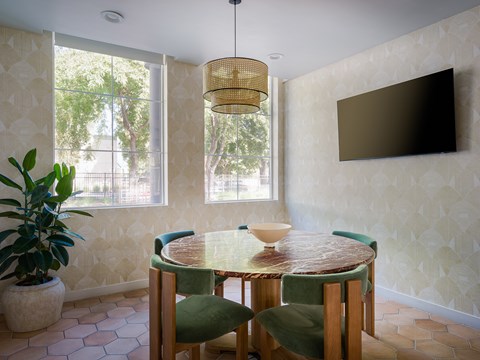 a dining room with a table and chairs and a tv