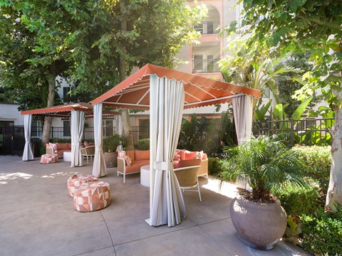a patio with couches and a canopy