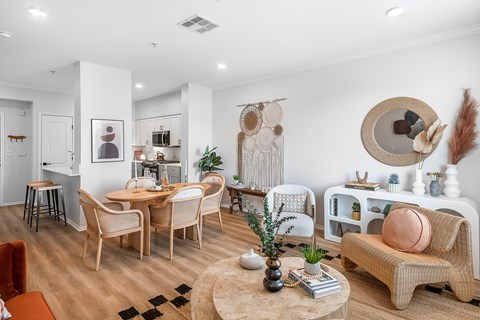 a living room with a table and chairs and a dining room