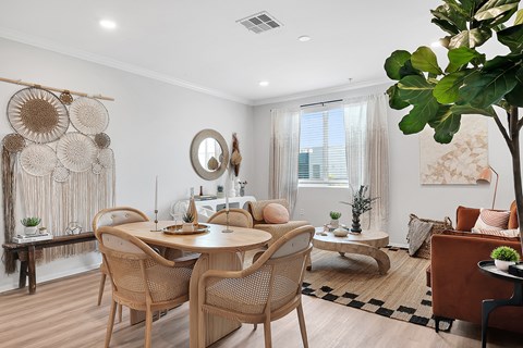 a living and dining room with white walls and a black and white checkered floor