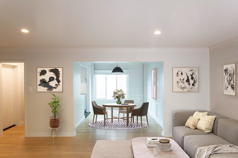 Living area leading into brightly lit dining room