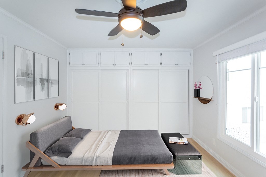 Bright bedroom with full sized bed and modern feel