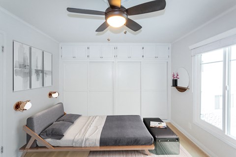 Bright bedroom with full sized bed and modern feel