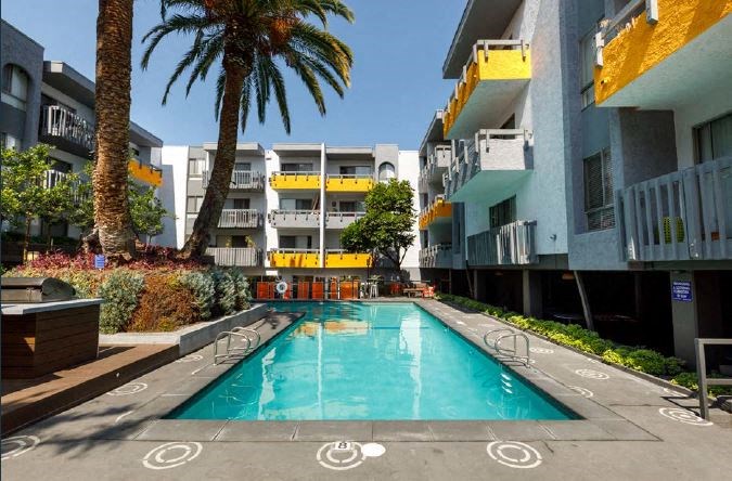 Refreshing Swimming Pool Surrounded by Palm Trees and with BBQ Pits