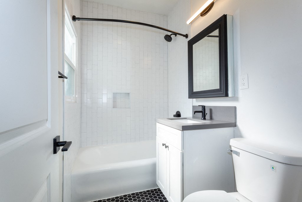Bathroom With White Cabinetry, Dual Shower and Tub and Modern Fixtures