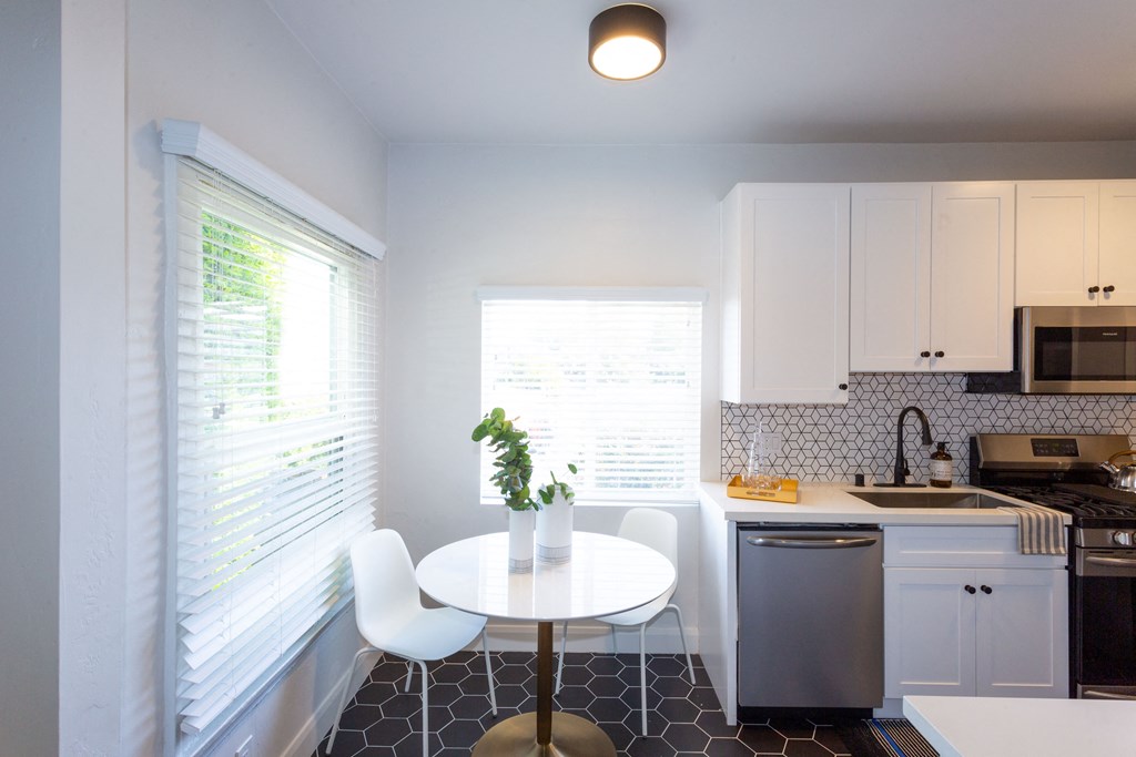 Dining Area With Hardwood Flooring, Breakfast Bar, Ceiling Fan and Modern Light Fixtures