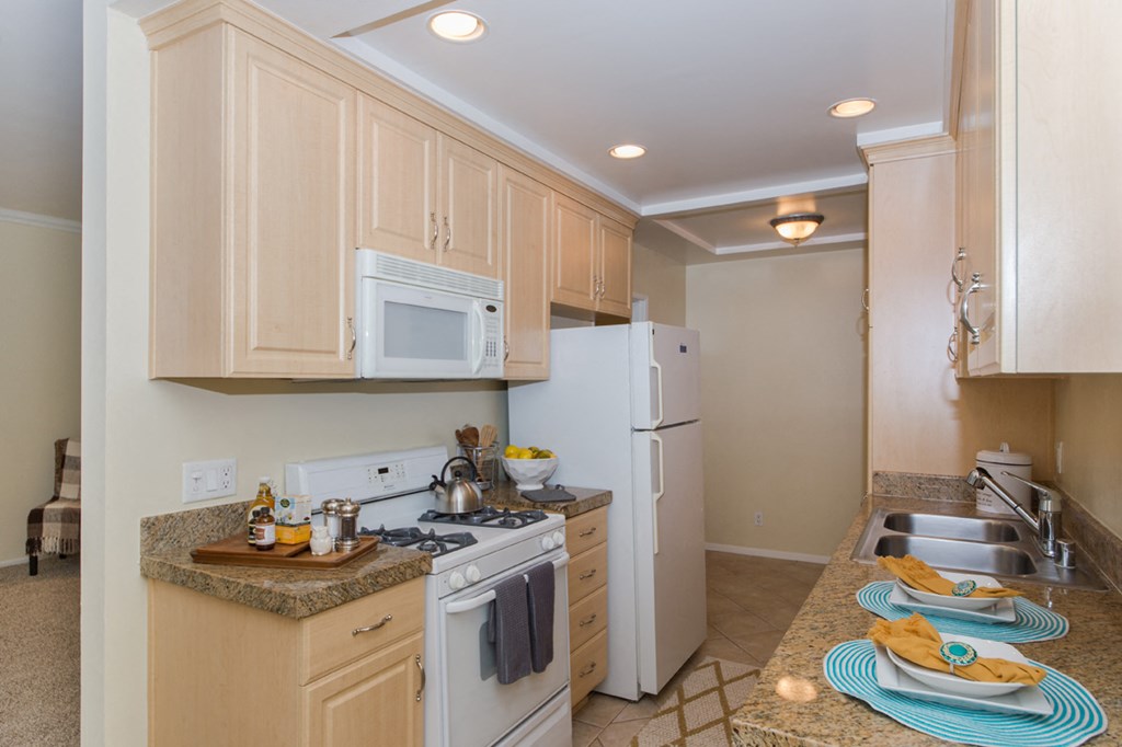 Bright kitchen with light wooden cabinets and white accents