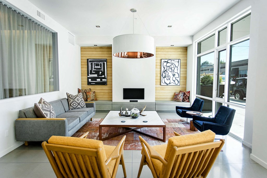 Arrival area lobby with chairs around a large coffee table