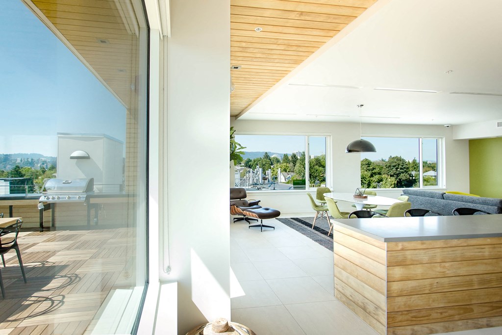 Rooftop clubhouse indoor with view of outdoor patio through window