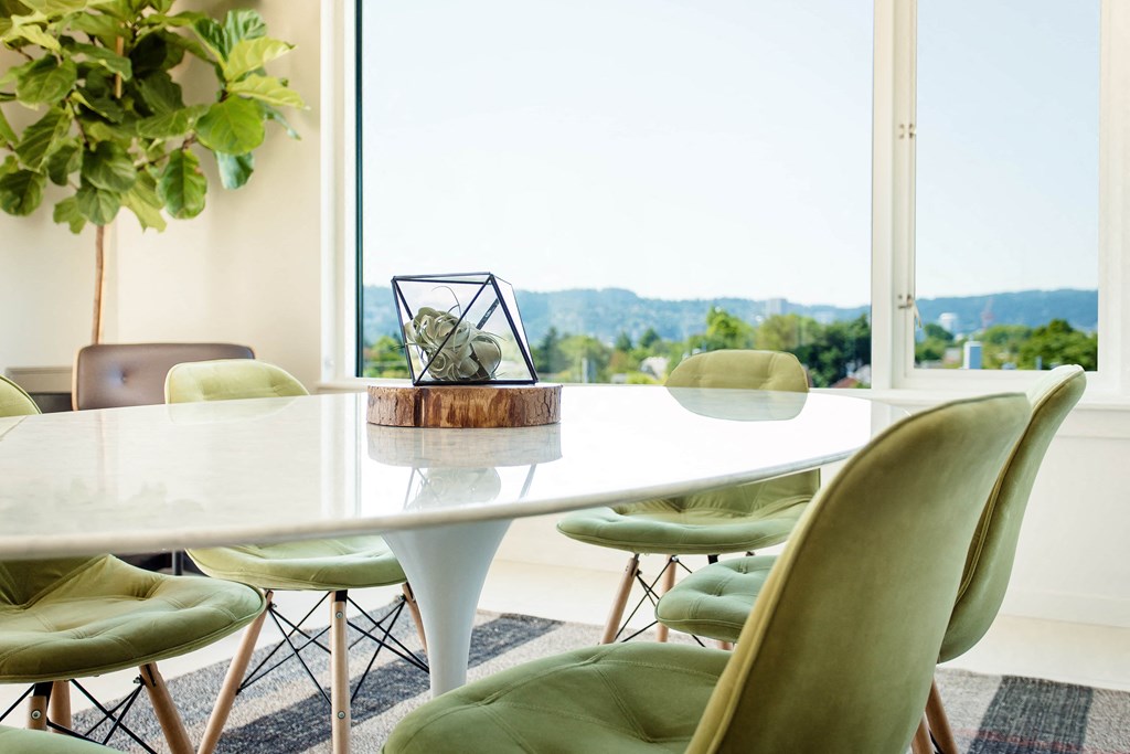 Table in rooftop clubhouse next to large window